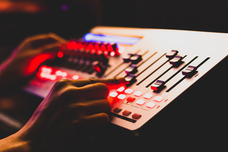 sound engineer, technician hands working on digital recording, broadcasting equipment in post...