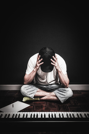male young songwriter worried and tense because he couldn't create desired good songの写真素材