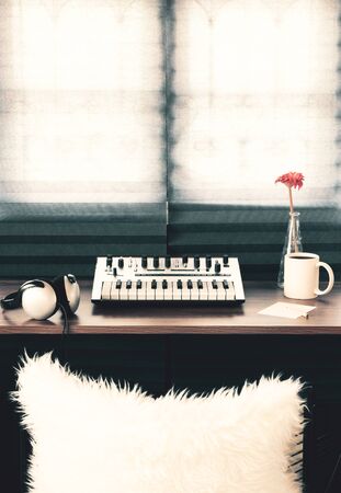 Analog synthesizer, headphone, blank paper on wooden table in the morning. Music, song writing conceptの写真素材