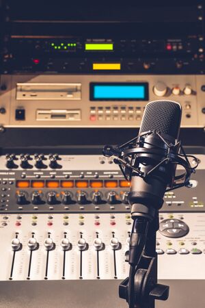 condenser microphone on audio mixing console and professional recording studio equipment backgroundの写真素材