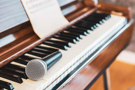 microphone on piano keys. music backgroundの写真素材