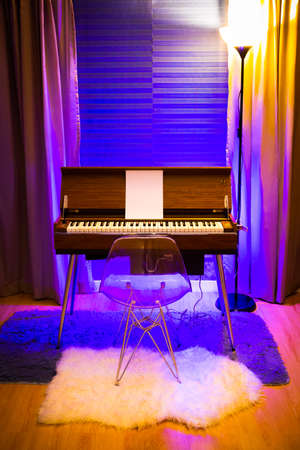 rare vintage reed organ in modern living room with colorful ambient light settingの写真素材