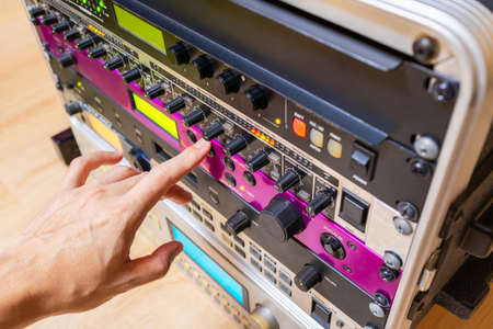 hand tuning knobs of studio gears, pre-amp, audio interface, effect signal processor. TV radio...