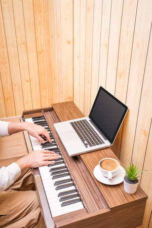 man enjoy learning music lesson online from internet in living room. e-learning technology concept