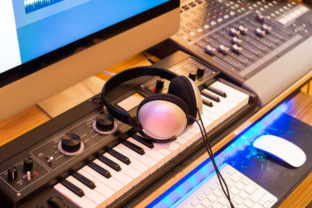 stereo headphone on keyboard synthesizer in home recording studio. music production equipment...