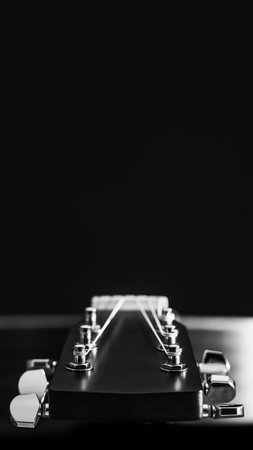 close up BW acoustic guitar tuning machine on headstock showing detail of steel strings. music backgroundの写真素材