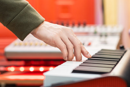 male musician hand playing on piano keys in studio. music backgroundの写真素材