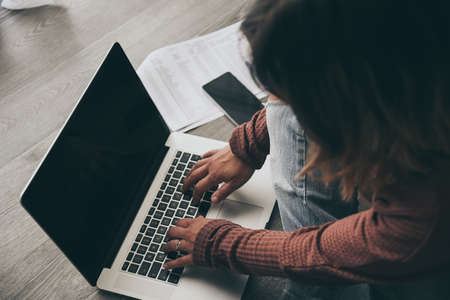 Young woman working on laptop at home. Female hands typing on pc keyboard. Tennager making an Internet video call with remote friends. Girl studying online. Technology, youth, teen, new life conceptの写真素材