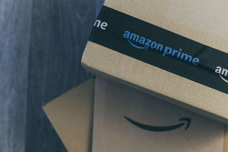 Boxes with Amazon logo on the floor. Order on delivery. Christmas gifts in cardboard box ready to be opened. Amazon Prime priority delivery E-commerce, shop on line concept Milan, Italy - October 2021のeditorial素材
