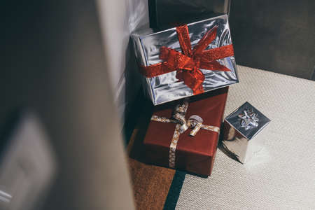 Stack of Christmas gift boxes in front of the house door. Order on delivery, box on the doormat. Transportation express service. E-commerce, business, online market, postal, and moving day concept.の写真素材
