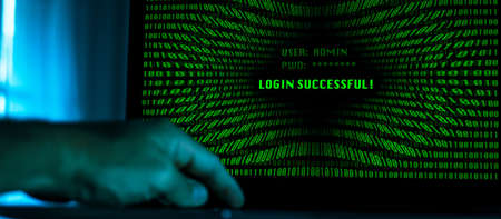 Hand typing on a laptop keyboard green numbers on display. Successful login with credentials user and password in the system. Technology communication, security protection, hacker, cyber crime conceptの写真素材