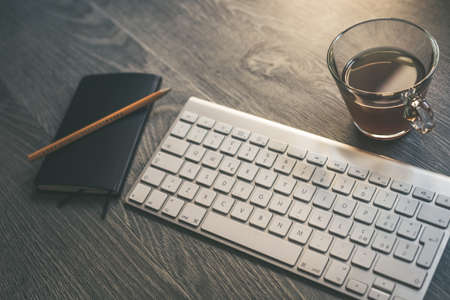 Desktop view with keyboard pencil agenda and technology devices. Table with objects for smart...