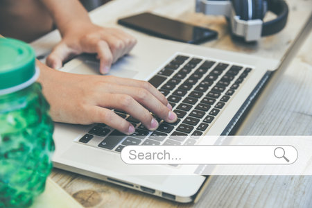 Searching data on internet concept. Working at laptop on desk Finding information online. Search barの写真素材