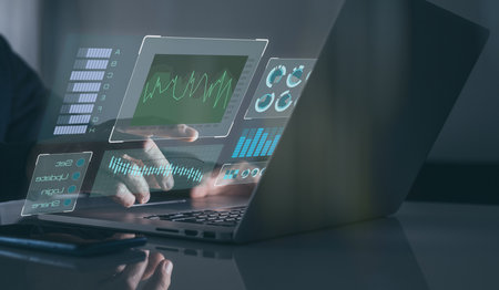 Graphs and charts on virtual computer screen. Businessman works statistical data on laptop in office