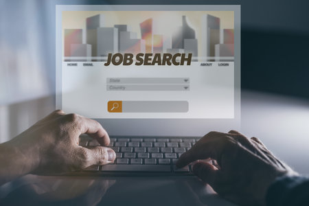 Closeup view of man's hands searching job online, finding occupation. Recruitment, hiring concept.の写真素材