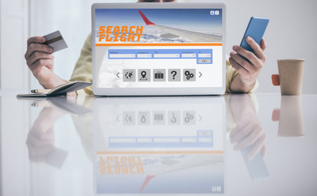 Man search and pay vacation tickets on laptop and phone. Booking flights. Plan travel, book holidaysの写真素材