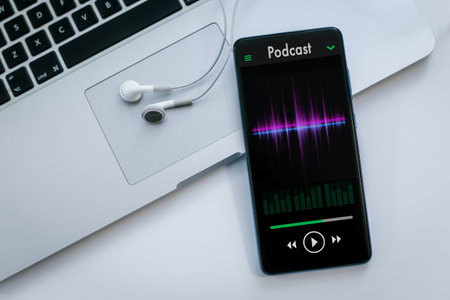 Smartphone and laptop playing podcasts. Radio broadcast, music and audio streaming concept.の写真素材