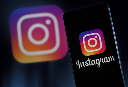 Instagram logo on smartphone screen and background. Milan Italy January 2023