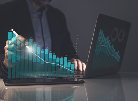 Businessman using laptop analyzing sales chart and economic growth. Business marketing strategy.の写真素材