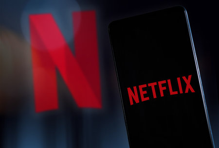 Netflix logo on smartphone screen and background. Streaming video concept. Milan Italy January 2023