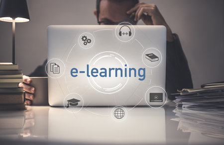 E-learning, education, study online concept. Man behind laptop on desk. E-learning on virtual displaysの写真素材