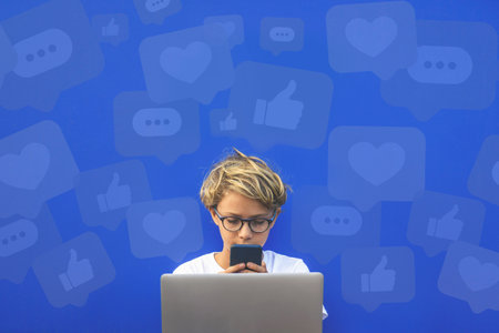 Young boy using laptop. Phone in hands. Like icons. Community social media communication concept