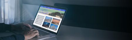 Man search tickets vacation on laptop. Booking flights. Plan travel, book holidays. Travel conceptの写真素材