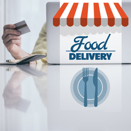Man behind computer purchase food online. Credit card in hand. Home delivery, fast food concept.の写真素材