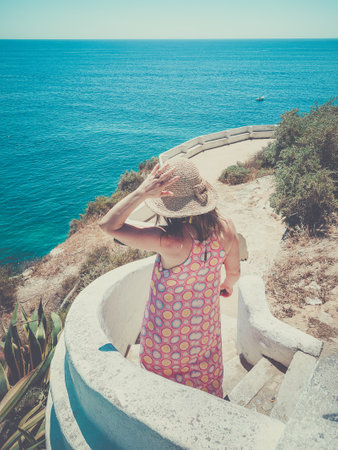 Beautiful girl enjoy summer exotic vacation, looking blue sea panorama. Travel holiday relaxation conceptの写真素材