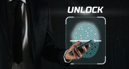 Businessman uses smartphone to authenticate online and log in to a web application. Security conceptの写真素材