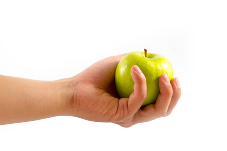 hand with green apple isolated on white backgroundの写真素材