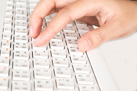 Office worker typing white keyboard.の写真素材