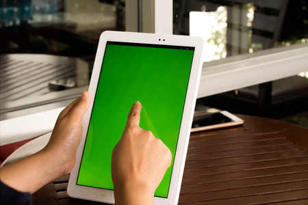 Closeup  tablet with green screen.