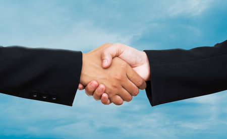 Hand shake on bokeh background cooperation concept.の写真素材