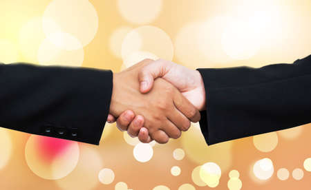 Hand shake on bokeh background cooperation concept.の写真素材