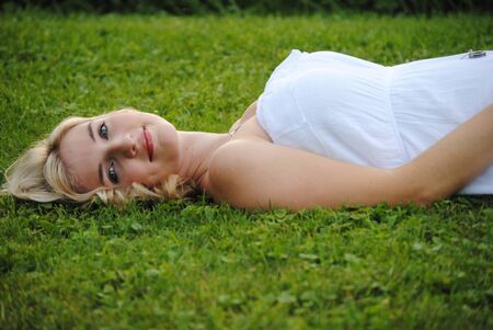lady laying in the grassの写真素材
