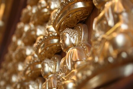 Golden buddha statue on the wall in Chinese temple, Thailandの写真素材