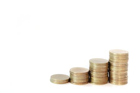 Increasing columns of gold coins isolated on white backgroundの写真素材