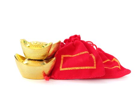 Ancient Chinese golden ingots and Chinese lucky red bags on white background, Chinese new year ornamentの写真素材