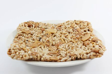 Krayasart, Thai sweet made of rice, nut, sesame-seeds and sugar on white backgroundの写真素材