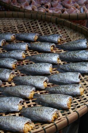 Stack of many dried and salted fish for cooking in Thai market, food preservationの写真素材
