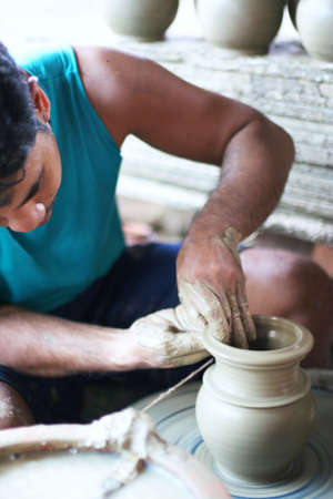 Pak Kret, Nonthaburi, Thailand - August 5th, 2007: Potter is creating earthenware from clay on...