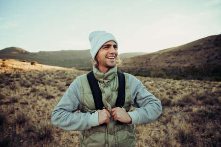Happy active male teen hiking in mountain enjoying fresh airの写真素材