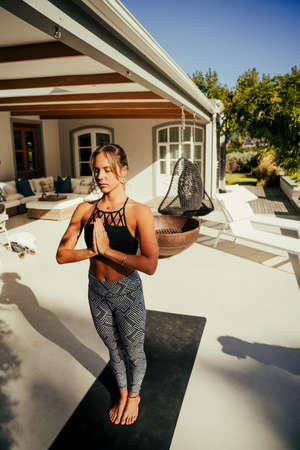 Caucasian female free spiting practising yoga outsideの写真素材