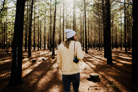Caucasian male photographer walking through luscious woodlandsの写真素材