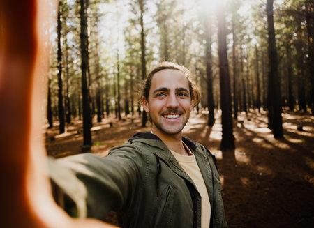 Self portrait of young happy male in the woods, selfieの写真素材