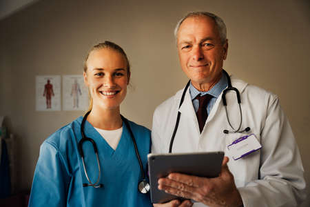 Portrait of Caucasian female and male doctor with digital tablet