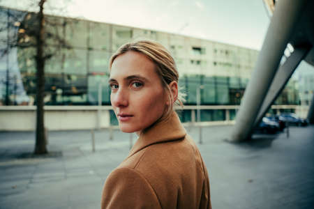 Beautiful caucasian business woman with blue eyes walking to workの写真素材