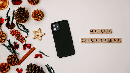 Merry Christmas banner concept with cellphone turned downの写真素材