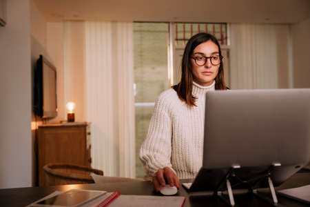 caucasian business women working from home typing on laptop writing emails to colleagues